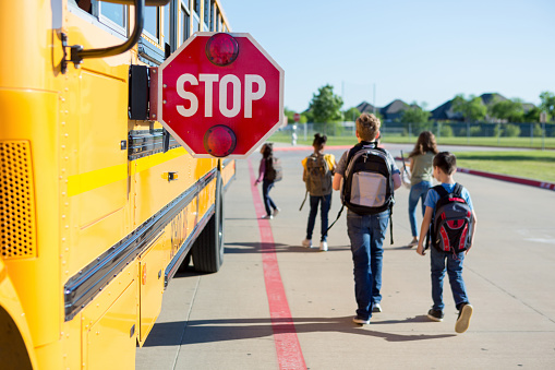 kids at school bus stop